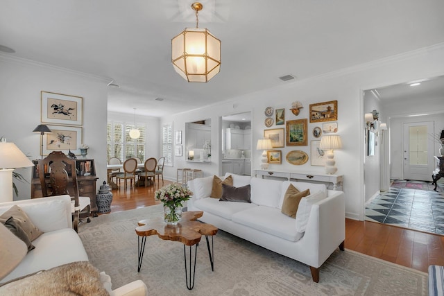 living room featuring hardwood / wood-style flooring and ornamental molding