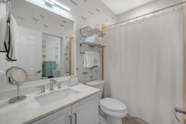 bathroom featuring vanity, toilet, and tile patterned flooring