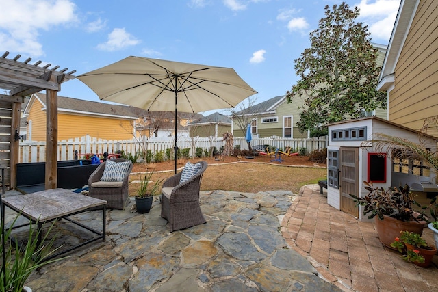 view of patio / terrace featuring a pergola and a shed