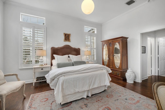 bedroom with multiple windows, ornamental molding, and dark hardwood / wood-style floors