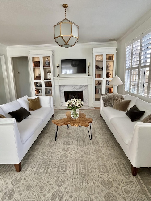 living room with ornamental molding and a premium fireplace