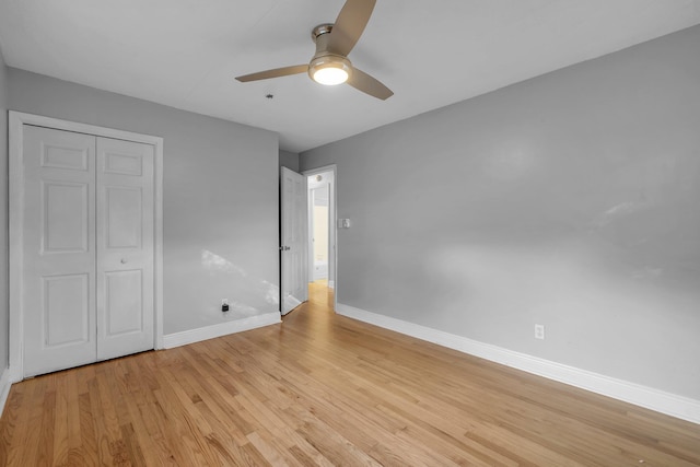 unfurnished bedroom with light wood-type flooring, a closet, and ceiling fan