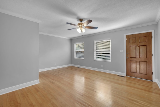 unfurnished room with a textured ceiling, light wood-type flooring, ceiling fan, and crown molding