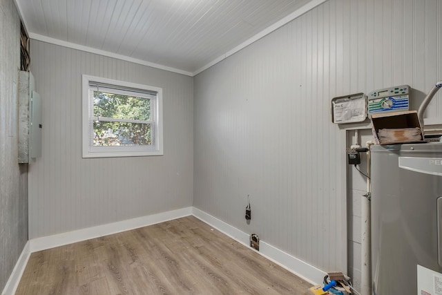 laundry area featuring electric water heater, light hardwood / wood-style floors, and ornamental molding