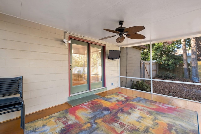 sunroom featuring ceiling fan