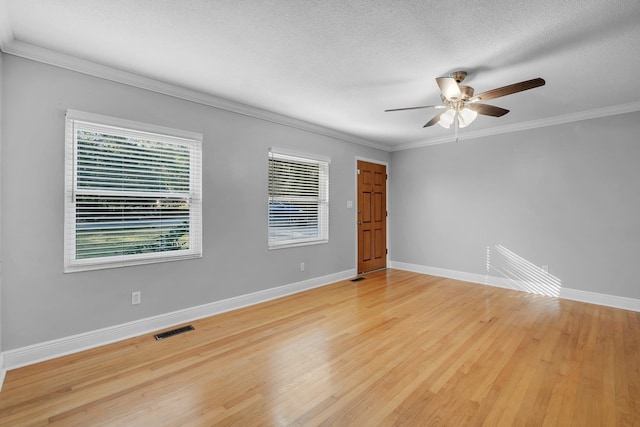 unfurnished room with ceiling fan, light wood-type flooring, and ornamental molding