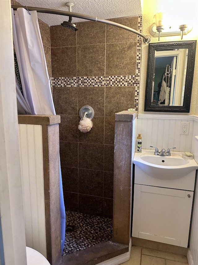 bathroom with tile patterned floors, vanity, and curtained shower