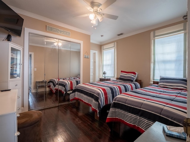 bedroom featuring ceiling fan, a closet, crown molding, and wood-type flooring