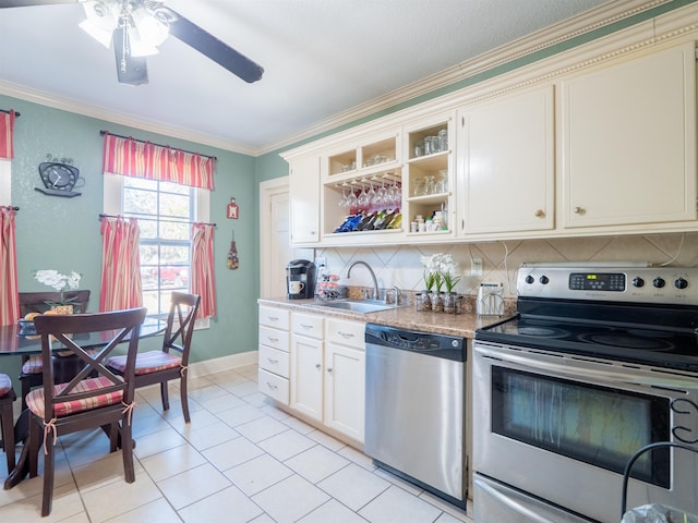 kitchen featuring appliances with stainless steel finishes, crown molding, light tile patterned floors, ceiling fan, and sink