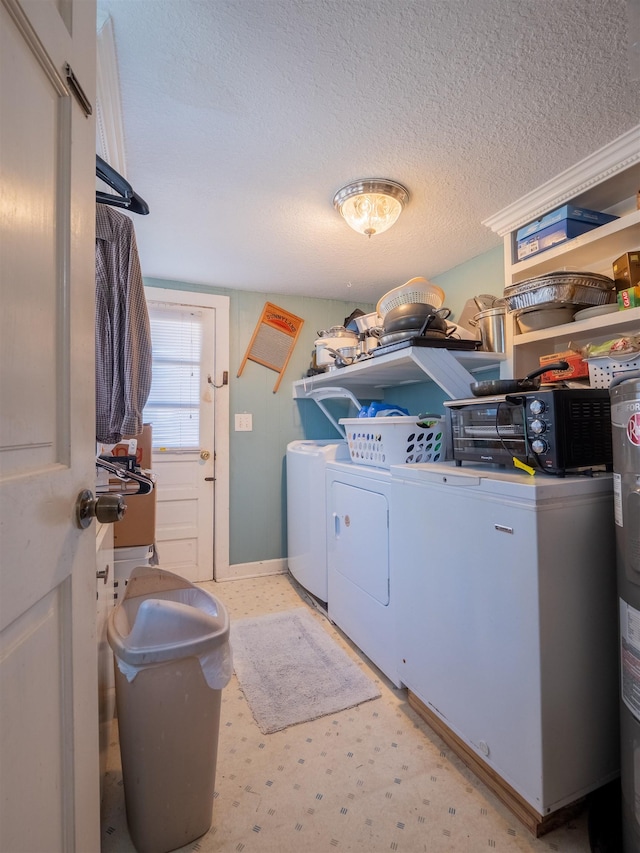 clothes washing area with a textured ceiling and separate washer and dryer