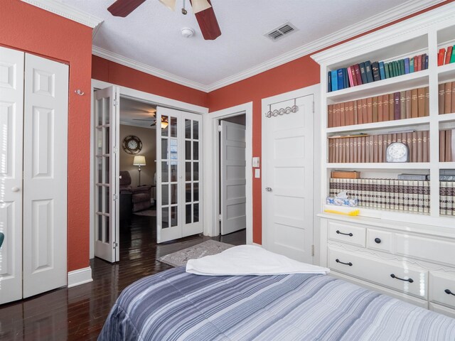 bedroom featuring ceiling fan, dark hardwood / wood-style flooring, french doors, and ornamental molding