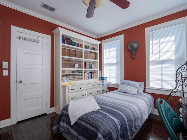 bedroom with dark wood-type flooring, ceiling fan, ornamental molding, and multiple windows