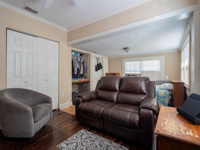 living room with ornamental molding, ceiling fan, and dark hardwood / wood-style floors