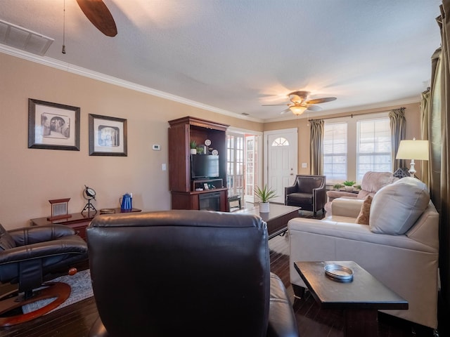 living room with ceiling fan, crown molding, and hardwood / wood-style floors