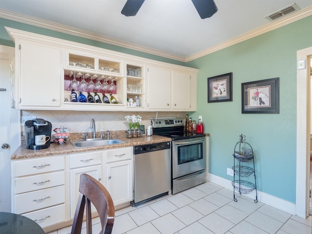 kitchen featuring stainless steel appliances, sink, white cabinets, tasteful backsplash, and crown molding