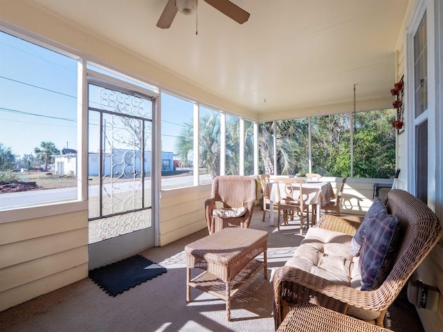 sunroom / solarium with a healthy amount of sunlight and ceiling fan