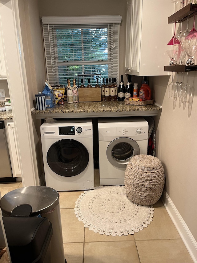 1045 Martin St, Tallahassee, FL 32303 - laundry room featuring tile patterned flooring, cabinet space, and independent washer and dryer