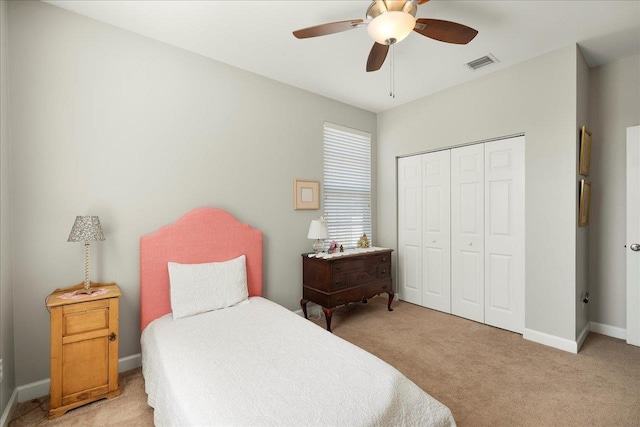 carpeted bedroom with a closet and ceiling fan