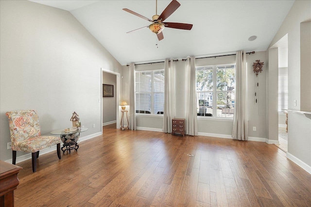 unfurnished room featuring hardwood / wood-style flooring, high vaulted ceiling, and ceiling fan