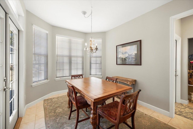 tiled dining room featuring a notable chandelier