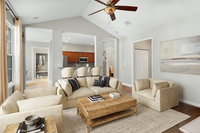 living room with light wood-type flooring, ceiling fan, baseboards, and visible vents