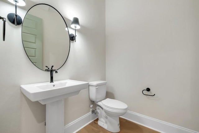 1261 N Duval St, Tallahassee, FL 32303 - half bathroom with baseboards, toilet, and wood finished floors
