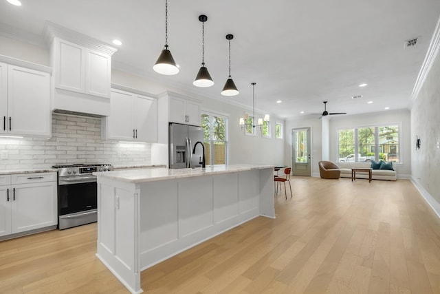 1261 N Duval St, Tallahassee, FL 32303 - kitchen with stainless steel appliances, ornamental molding, backsplash, an island with sink, and light wood-style floors