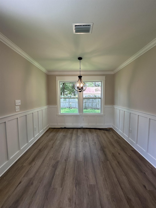 71 Chickat Trl, Crawfordville, FL 32327 - unfurnished dining area with a chandelier, wainscoting, a decorative wall, ornamental molding, and dark wood-style flooring