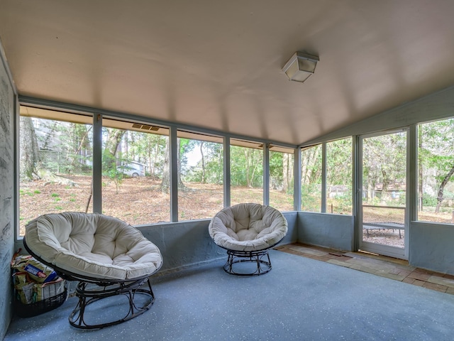 sunroom featuring vaulted ceiling