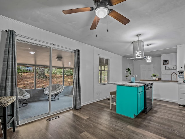 kitchen with a breakfast bar area, a kitchen island, island exhaust hood, dark wood-style flooring, and range with electric stovetop