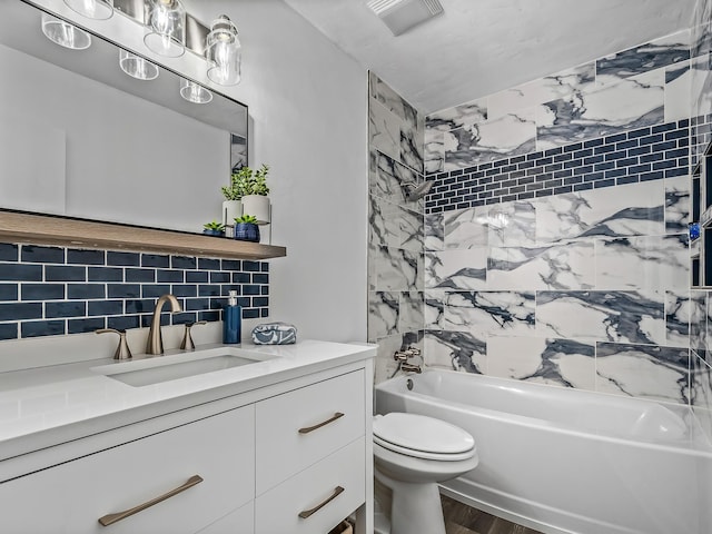 bathroom featuring visible vents, toilet, decorative backsplash, bathtub / shower combination, and vanity