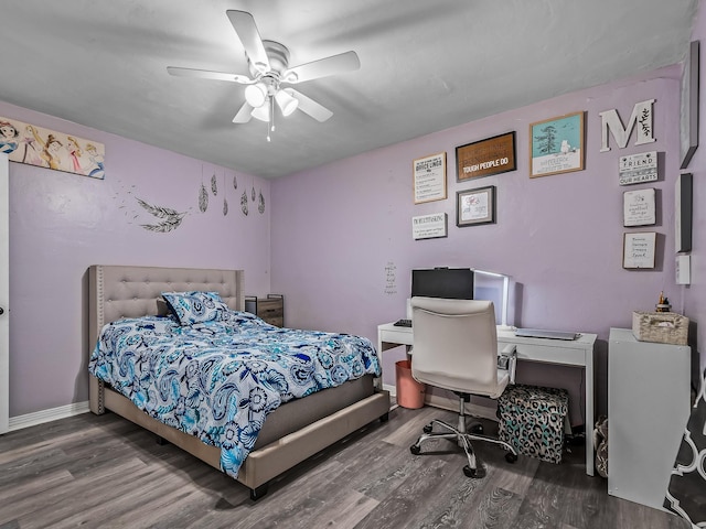 bedroom with ceiling fan, baseboards, and wood finished floors