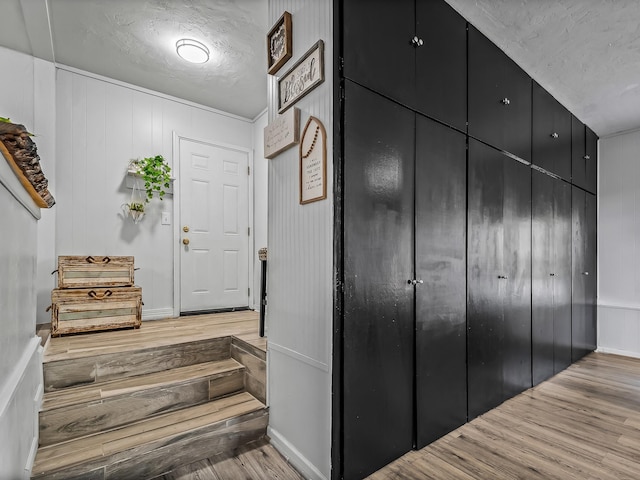 entryway featuring a textured ceiling and wood finished floors