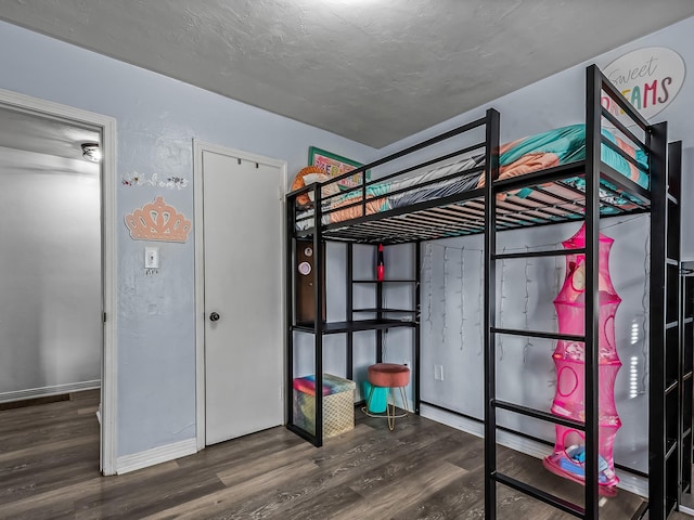 unfurnished bedroom featuring baseboards and wood finished floors