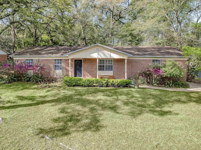 ranch-style home featuring brick siding and a front lawn