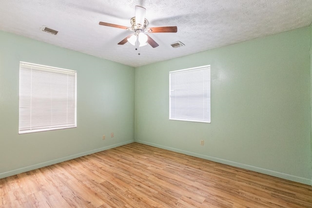 405 Mercury Dr, Tallahassee, FL 32305 - spare room with light wood-type flooring, a ceiling fan, and a textured ceiling