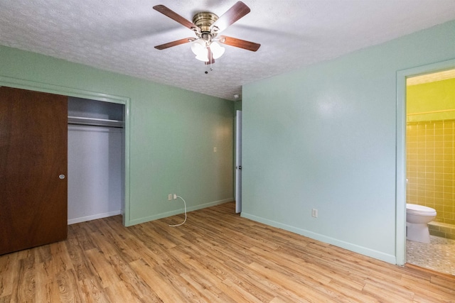 405 Mercury Dr, Tallahassee, FL 32305 - unfurnished bedroom with wood finished floors, a textured ceiling, a closet, ensuite bathroom, and ceiling fan