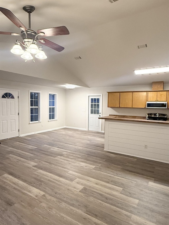 unfurnished living room featuring light wood-type flooring, lofted ceiling, and ceiling fan