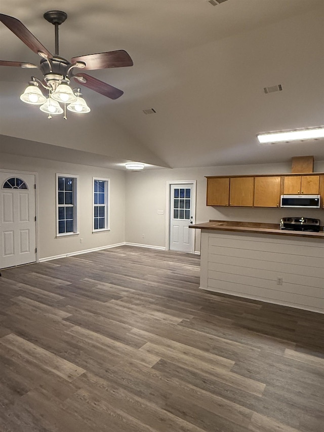 unfurnished living room with ceiling fan, vaulted ceiling, and dark hardwood / wood-style flooring