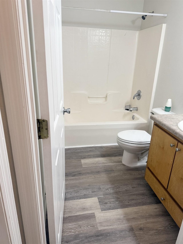 full bathroom featuring hardwood / wood-style flooring, toilet, vanity, and shower / bathing tub combination