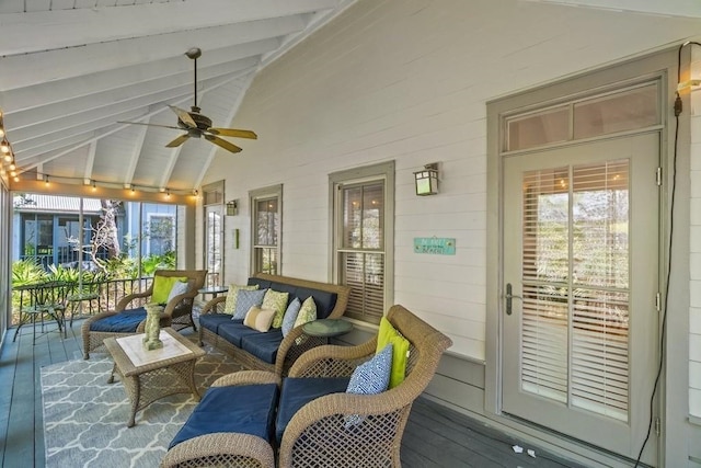 interior space with lofted ceiling with beams, a wealth of natural light, and ceiling fan