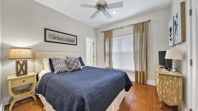 bedroom with hardwood / wood-style flooring and ceiling fan