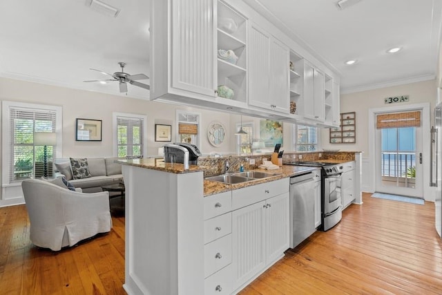 kitchen with white cabinets, stone countertops, light hardwood / wood-style flooring, and ornamental molding