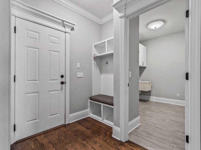 mudroom with baseboards, ornamental molding, and wood finished floors