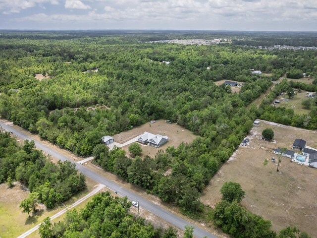 drone / aerial view with a view of trees