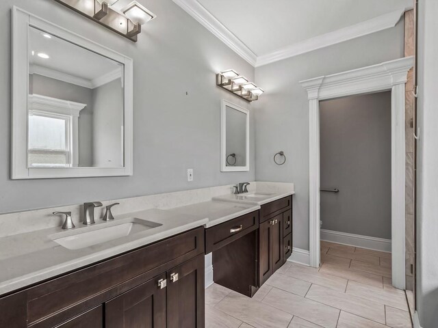 full bath featuring double vanity, ornamental molding, a sink, and toilet