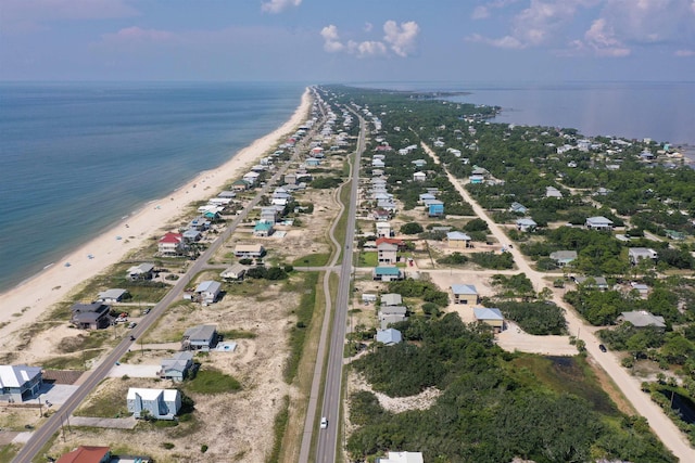 birds eye view of property with a water view and a view of the beach