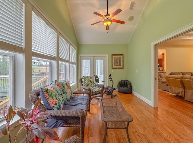 living area with ceiling fan, visible vents, a wealth of natural light, and light wood-style floors
