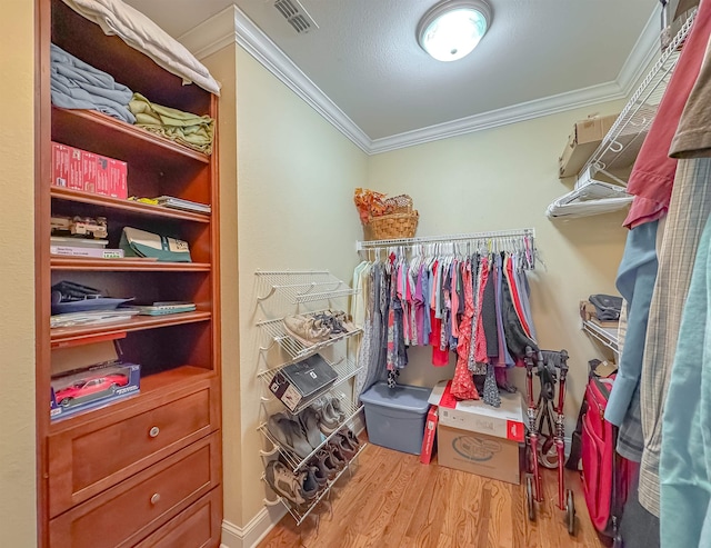 walk in closet with wood finished floors and visible vents
