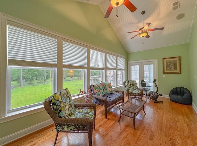 living room featuring light wood-type flooring, a ceiling fan, baseboards, and visible vents